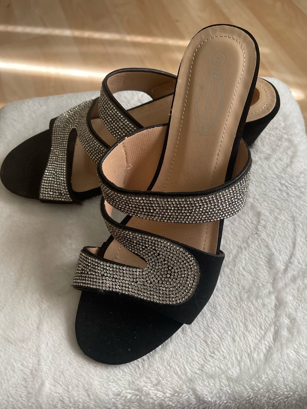 Elegant black wedge heels with silver design on top